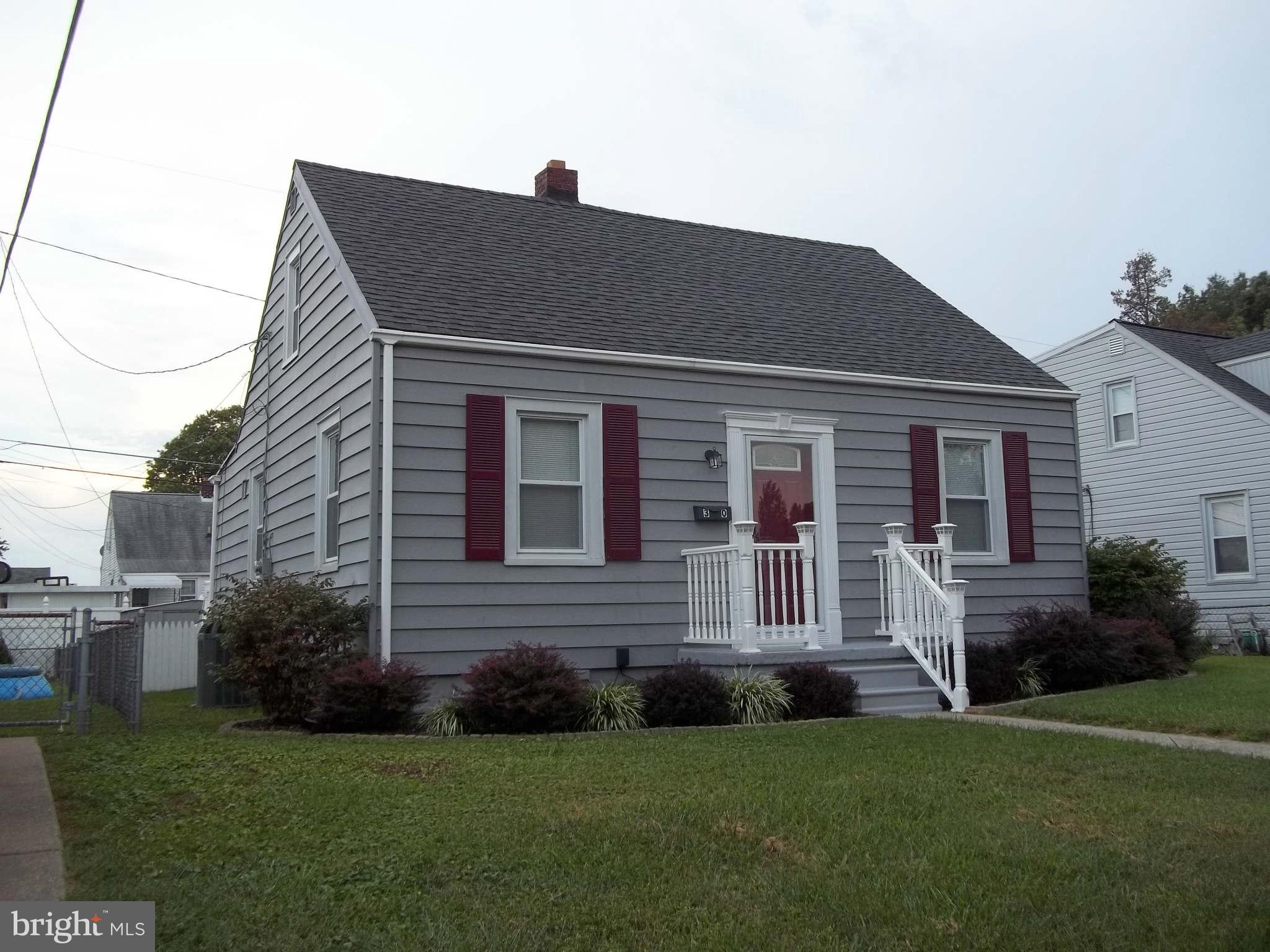 30 Crafton Road Baltimore, MD 21221 - Photo 2 of 17 a front view of a house with a garden