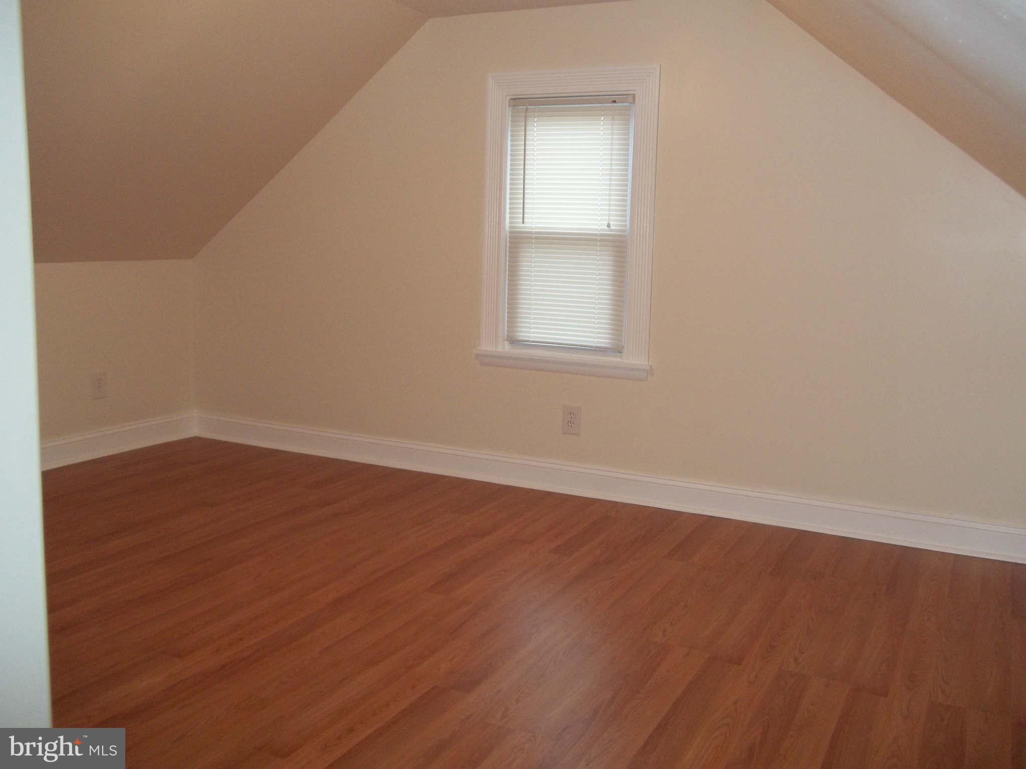 30 Crafton Road Baltimore, MD 21221 - Photo 12 of 17 an empty room with wooden floor and windows