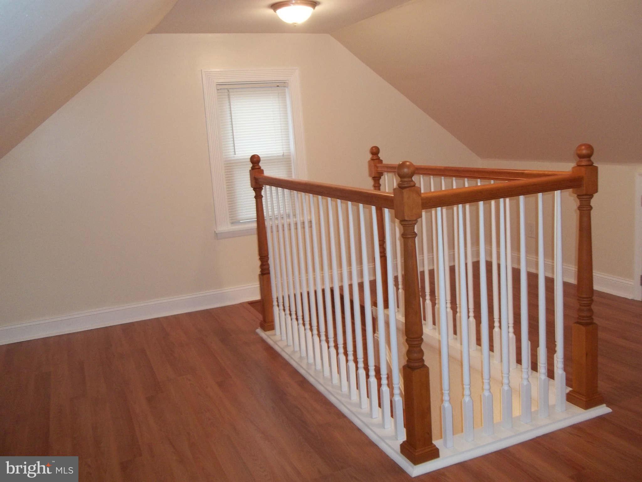 30 Crafton Road Baltimore, MD 21221 - Photo 13 of 17 a view of a hallway with wooden floor and stairs
