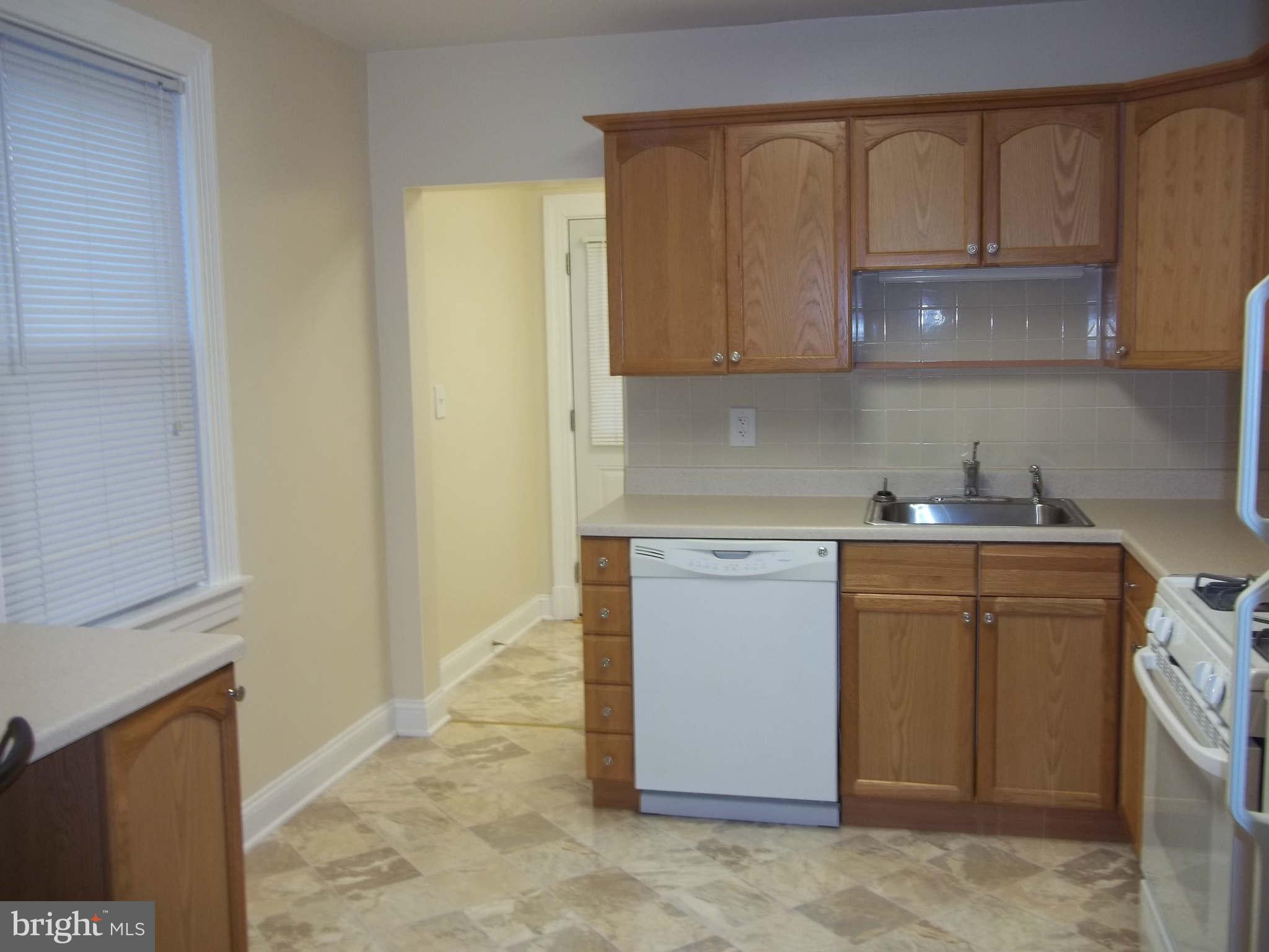 30 Crafton Road Baltimore, MD 21221 - Photo 15 of 17 a utility room with granite countertop cabinets washer and dryer