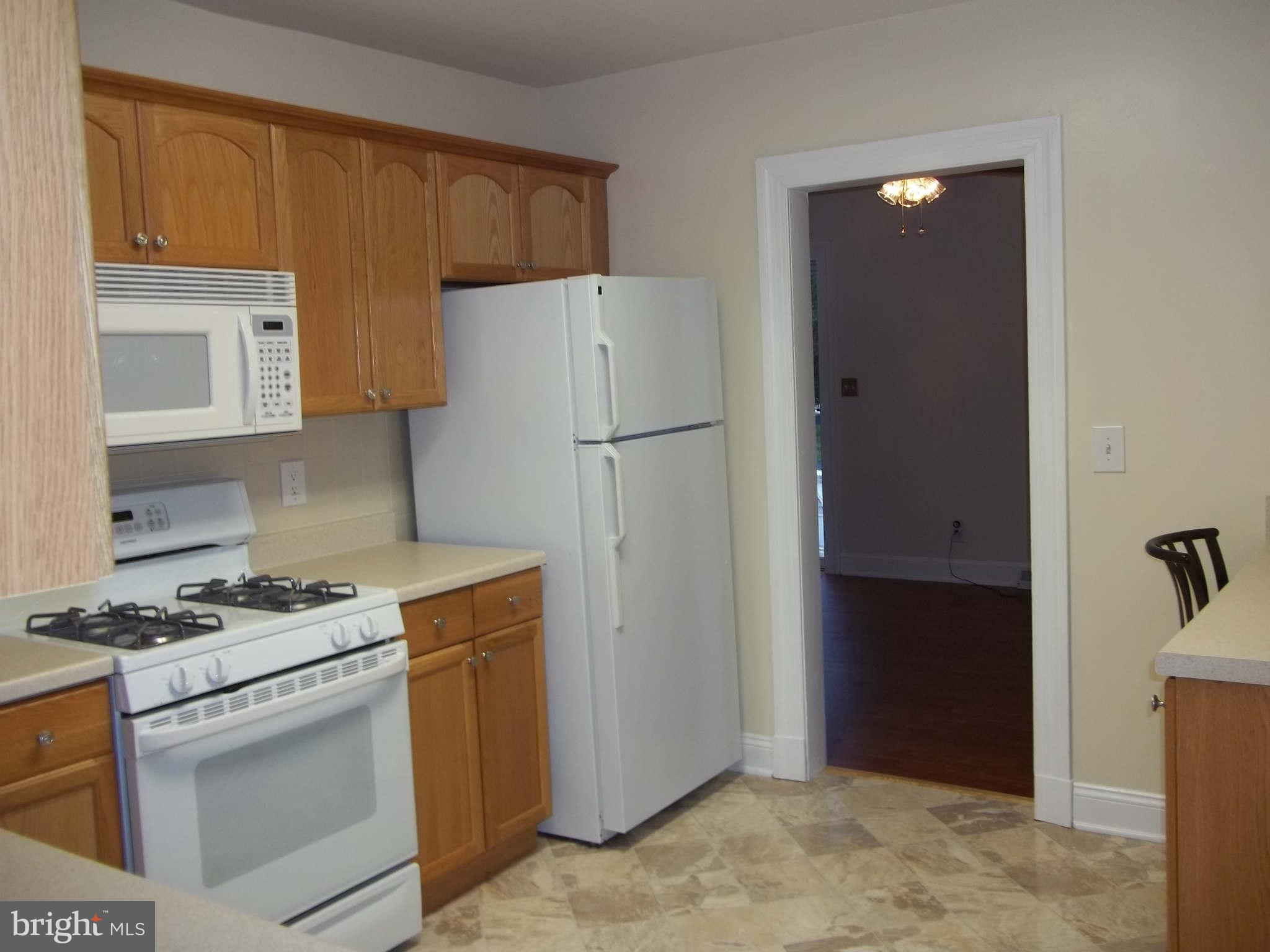30 Crafton Road Baltimore, MD 21221 - Photo 16 of 17 a kitchen with a stove and a refrigerator