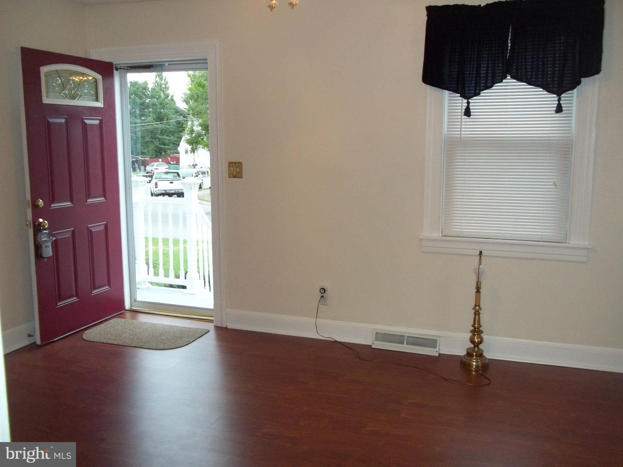 30 Crafton Road Baltimore, MD 21221 - Photo 6 of 17 an empty room with wooden floor and windows