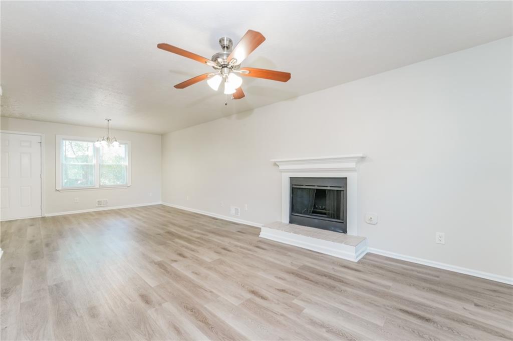 884 3rd Street Stone Mountain, GA 30083 - Photo 16 of 26 an empty room with wooden floor fan and windows