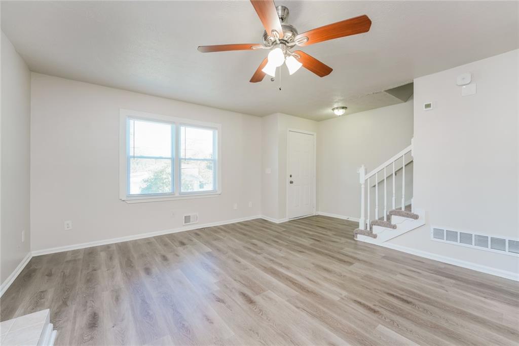 884 3rd Street Stone Mountain, GA 30083 - Photo 17 of 26 wooden floor in an empty room with a window