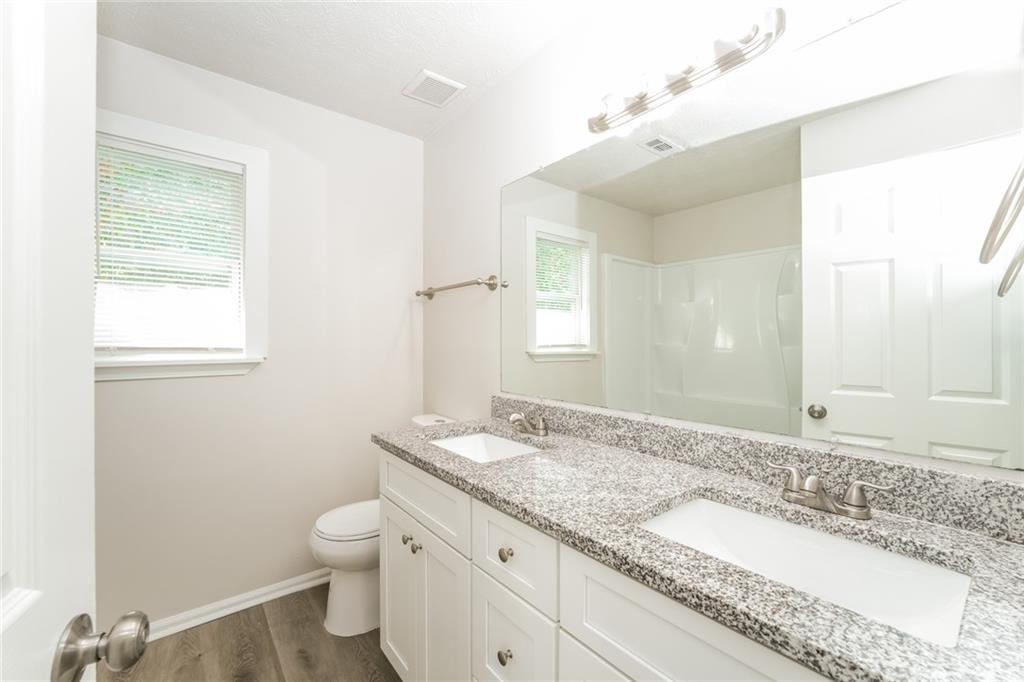 884 3rd Street Stone Mountain, GA 30083 - Photo 19 of 26 a bathroom with a granite countertop sink and a mirror