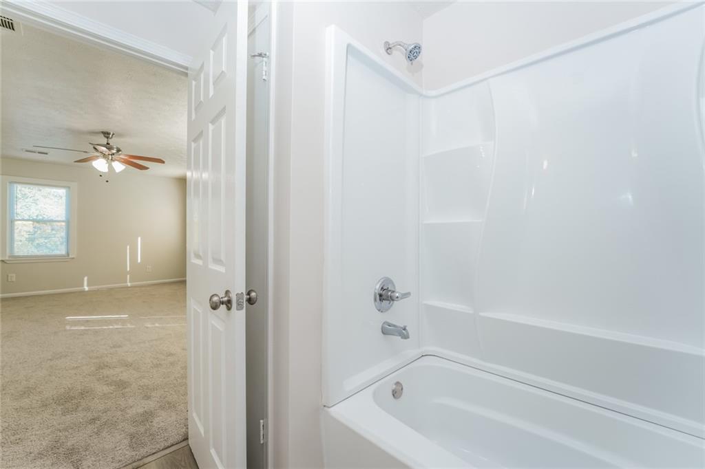 884 3rd Street Stone Mountain, GA 30083 - Photo 20 of 26 a bathroom with a bathtub and a shower
