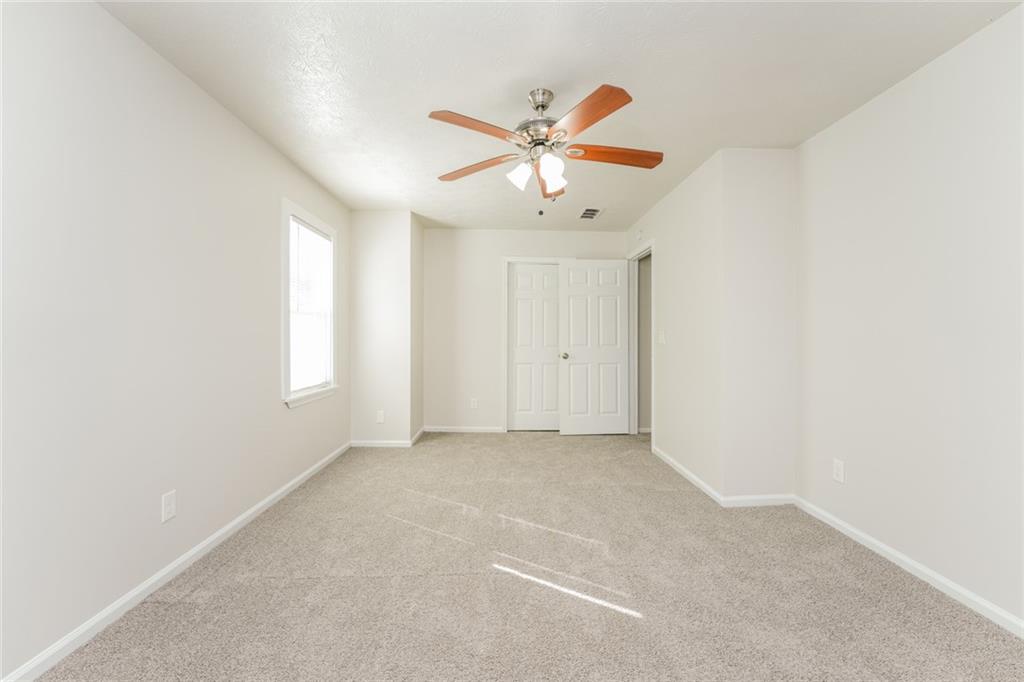 884 3rd Street Stone Mountain, GA 30083 - Photo 21 of 26 an empty room with a window and a fan