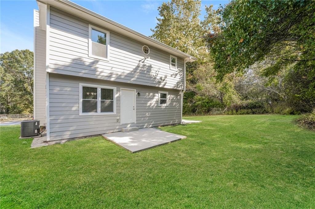 884 3rd Street Stone Mountain, GA 30083 - Photo 23 of 26 a backyard of a house with lots of green space