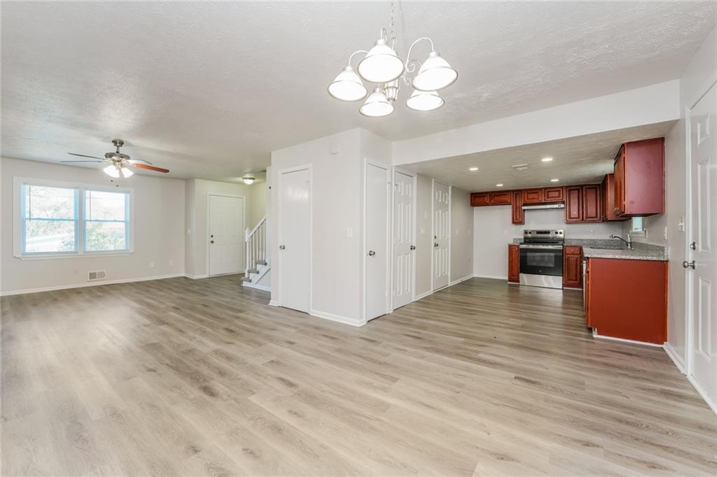884 3rd Street Stone Mountain, GA 30083 - Photo 3 of 26 a view of kitchen with cabinets and wooden floor