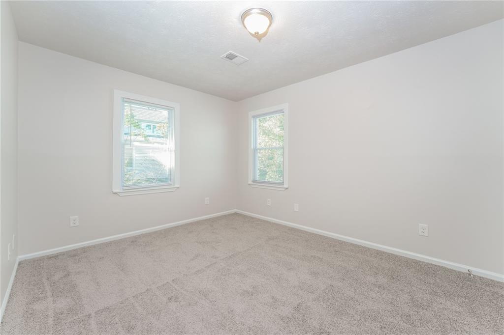 884 3rd Street Stone Mountain, GA 30083 - Photo 5 of 26 an empty room with windows