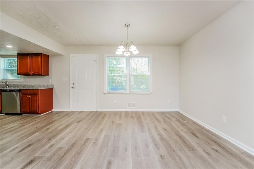 884 3rd Street Stone Mountain, GA 30083 - Photo 9 of 26 wooden floor in an empty room with a window