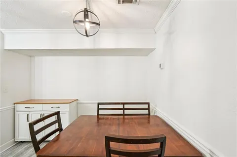 a hallway with chairs and wooden floor