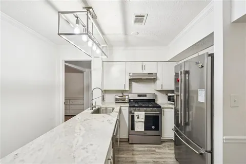 a kitchen with stainless steel appliances a refrigerator stove and oven