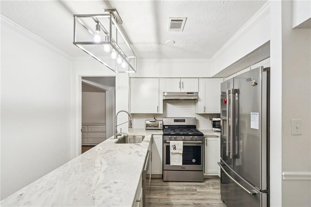 2071 Brian Way Decatur, GA 30033 - Photo 17 of 28 a kitchen with stainless steel appliances a refrigerator stove and oven