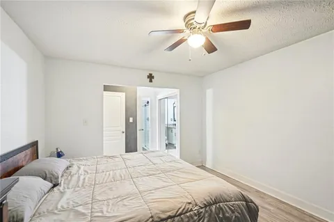 a bedroom with a large bed and a chandelier