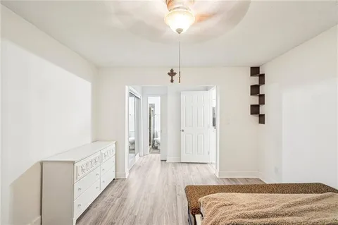 a bedroom with a bed and a chandelier