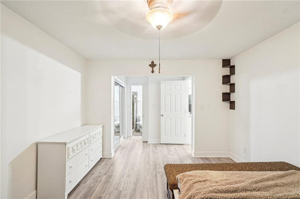 2071 Brian Way Decatur, GA 30033 - Photo 22 of 28 a bedroom with a bed and a chandelier