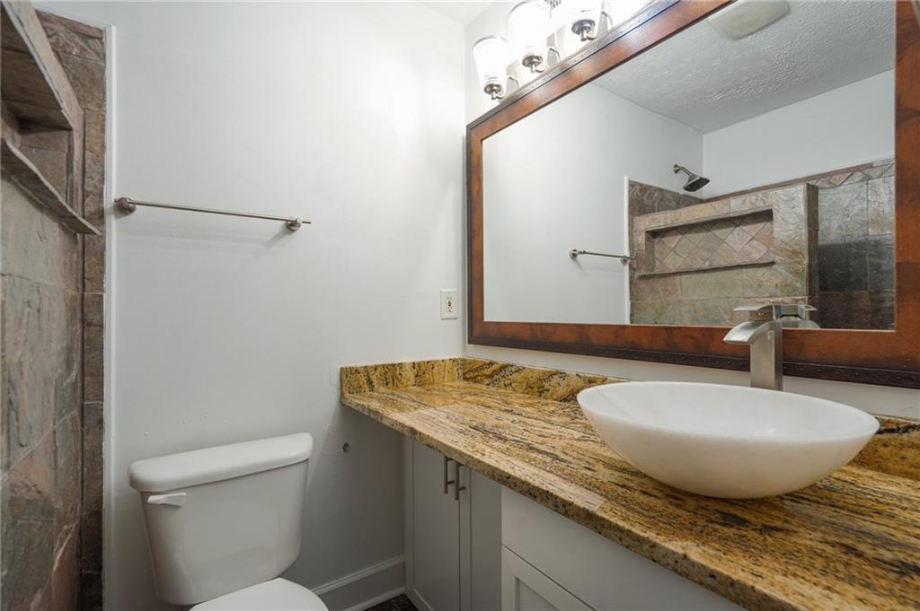 2071 Brian Way Decatur, GA 30033 - Photo 23 of 28 a bathroom with a granite countertop sink and a mirror