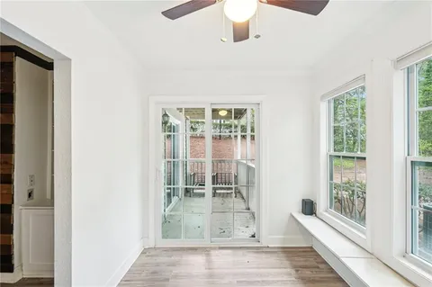 a view of an entryway with wooden floor and a rug