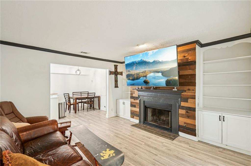 2071 Brian Way Decatur, GA 30033 - Photo 10 of 28 a living room with furniture a fireplace and a flat screen tv