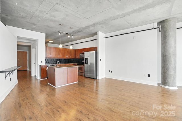 a view of kitchen with stainless steel appliances a refrigerator and cabinets