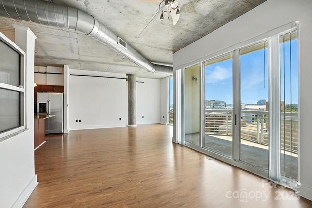 a view of a livingroom with a ceiling fan and window