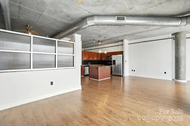 a view of a kitchen with wooden floor and kitchen