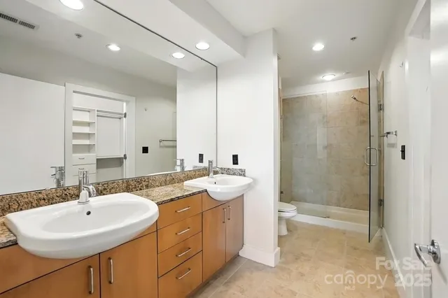 a bathroom with a sink double vanity and a shower