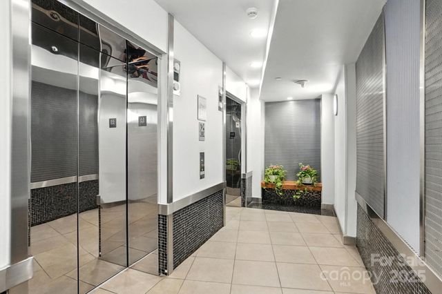 a bathroom with a tub shower and mirror