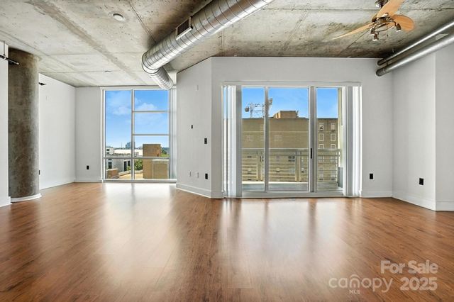 a view of a livingroom with wooden floor and a window