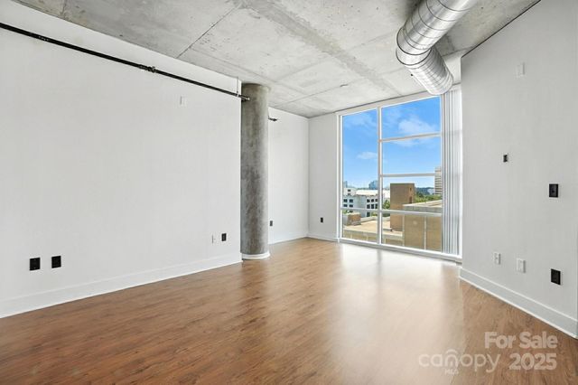 a view of a kitchen with a sink and a refrigerator