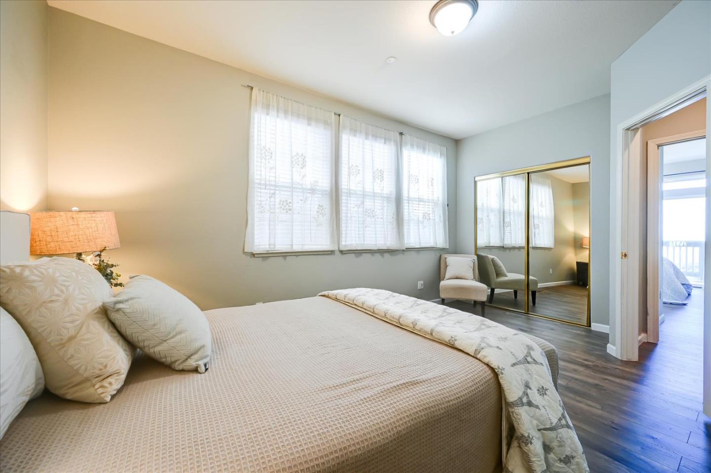 208 Goodwin Drive San Bruno, CA 94066 - Photo 33 of 45 a bedroom with a bed and a chandelier