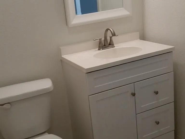 304 Fulton Street, Unit B Denton, TX 76201 - Photo 6 of 10 Half bathroom featuring vanity and toilet