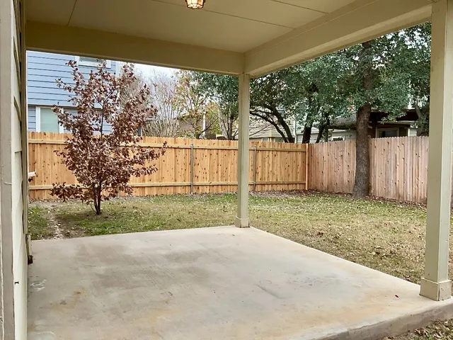 a view of a backyard with large trees