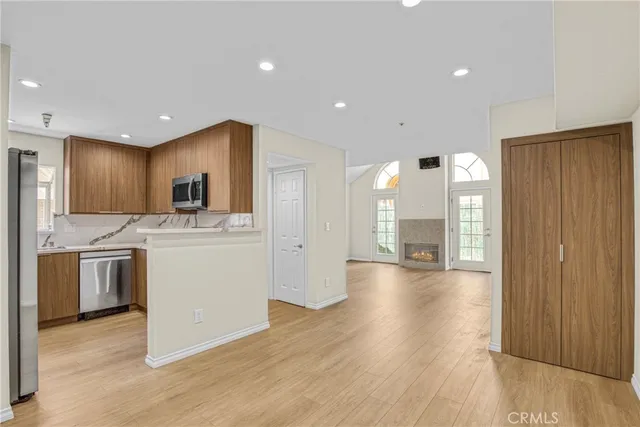 a view of a kitchen with a sink and a refrigerator