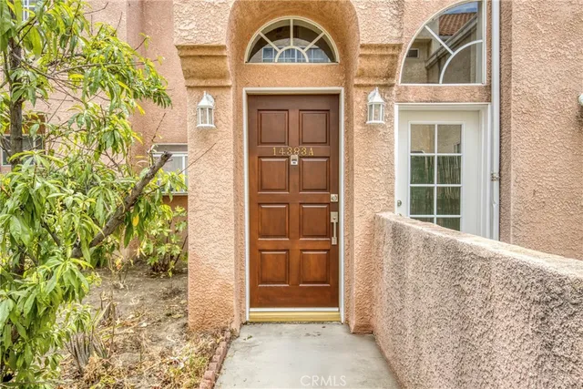 front view of a brick house with a large window