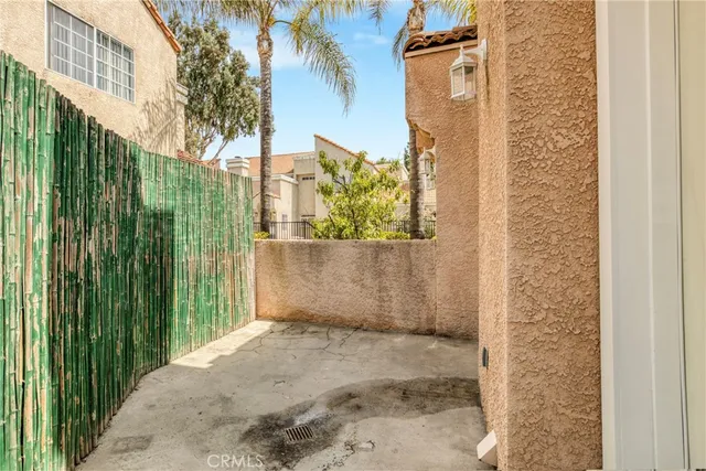 a view of a house with a yard and palm trees