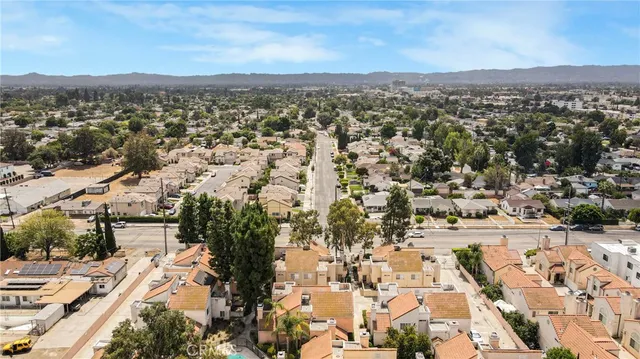 an aerial view of residential houses with outdoor space and trees