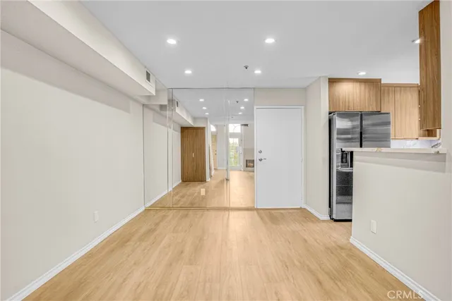 a view of empty room with wooden floor
