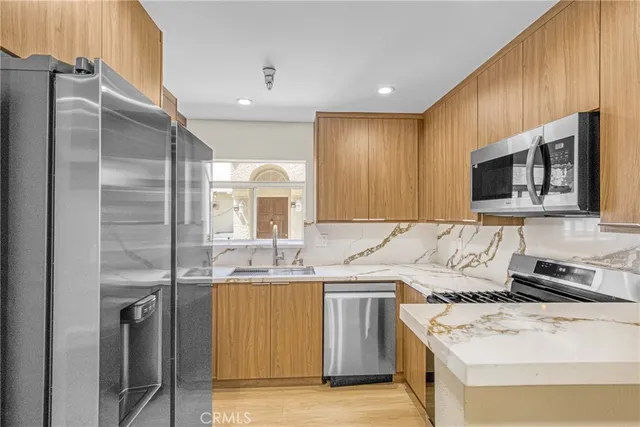 a kitchen with a sink stove and refrigerator