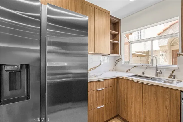 a kitchen with a refrigerator and sink