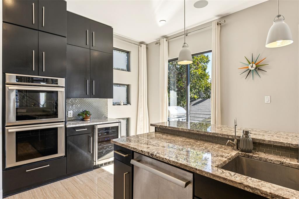 4420 Holland Avenue, Unit A Dallas, TX 75219 - Photo 11 of 32 a kitchen with a sink stove and microwave