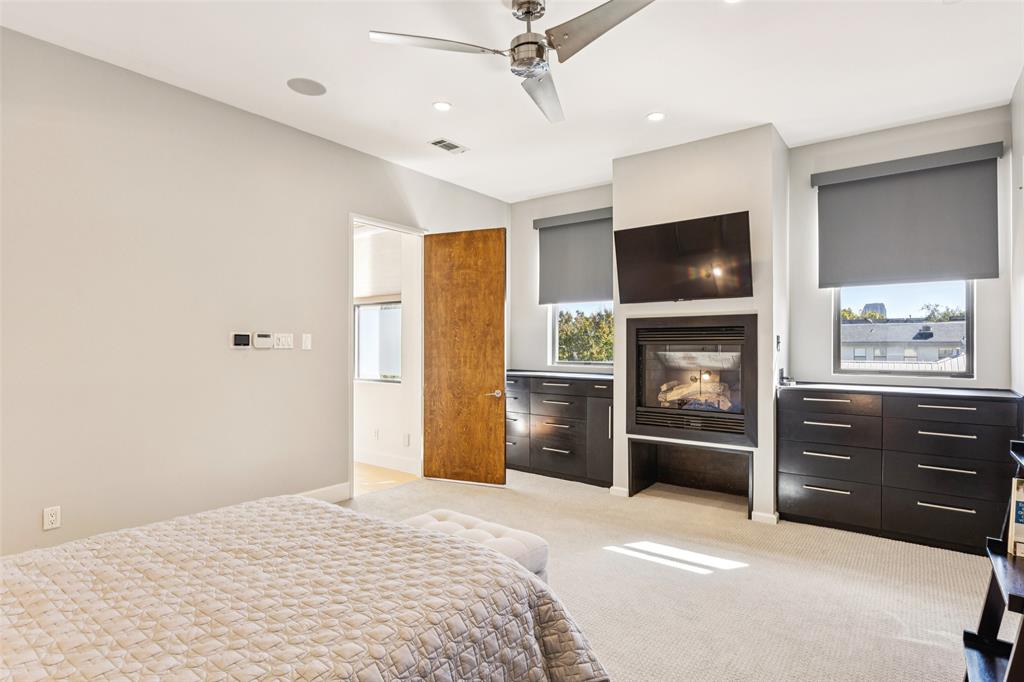 4420 Holland Avenue, Unit A Dallas, TX 75219 - Photo 14 of 32 a bedroom with a bed and a television