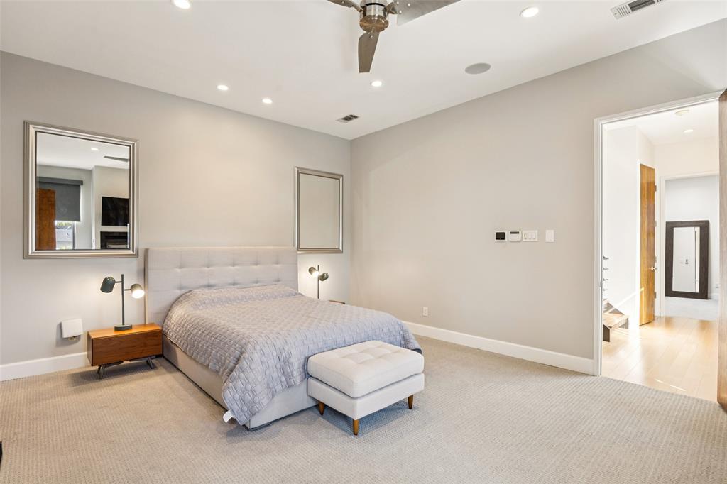 4420 Holland Avenue, Unit A Dallas, TX 75219 - Photo 19 of 32 a bedroom with a bed and a lamp