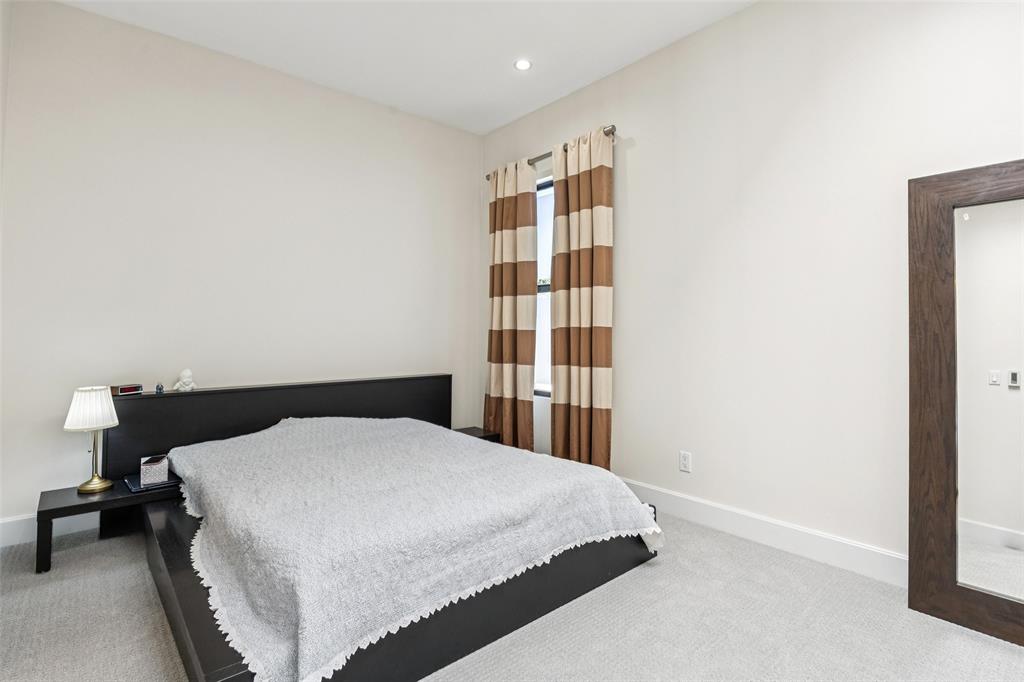 4420 Holland Avenue, Unit A Dallas, TX 75219 - Photo 21 of 32 a bedroom with a bed and walk in closet