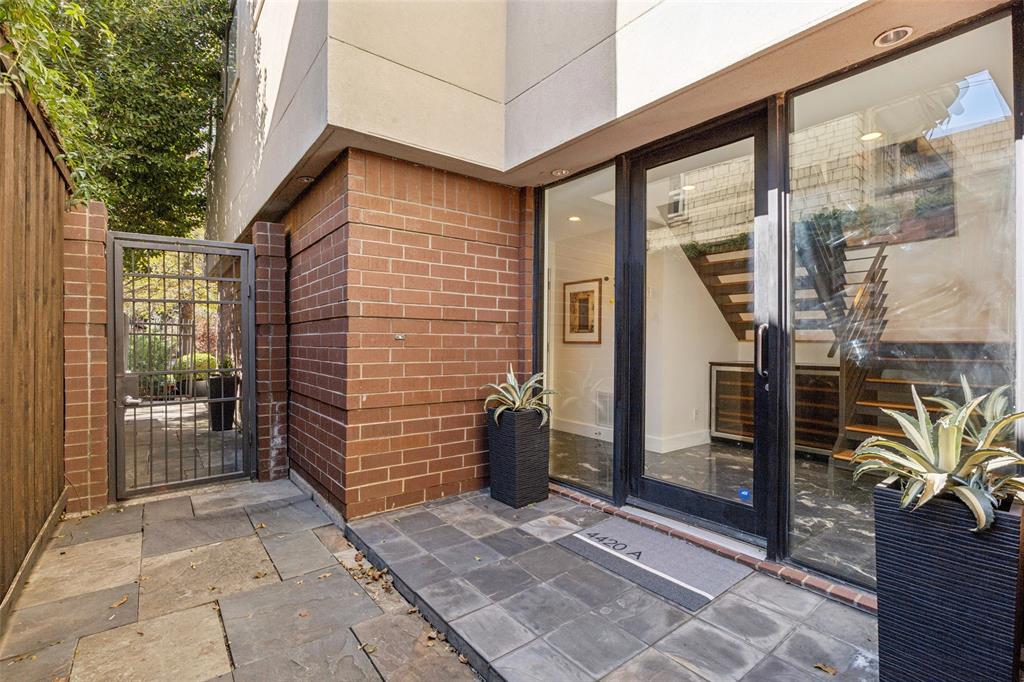 4420 Holland Avenue, Unit A Dallas, TX 75219 - Photo 26 of 32 Private gated entry and side patio, offering extra outdoor space and secure access.