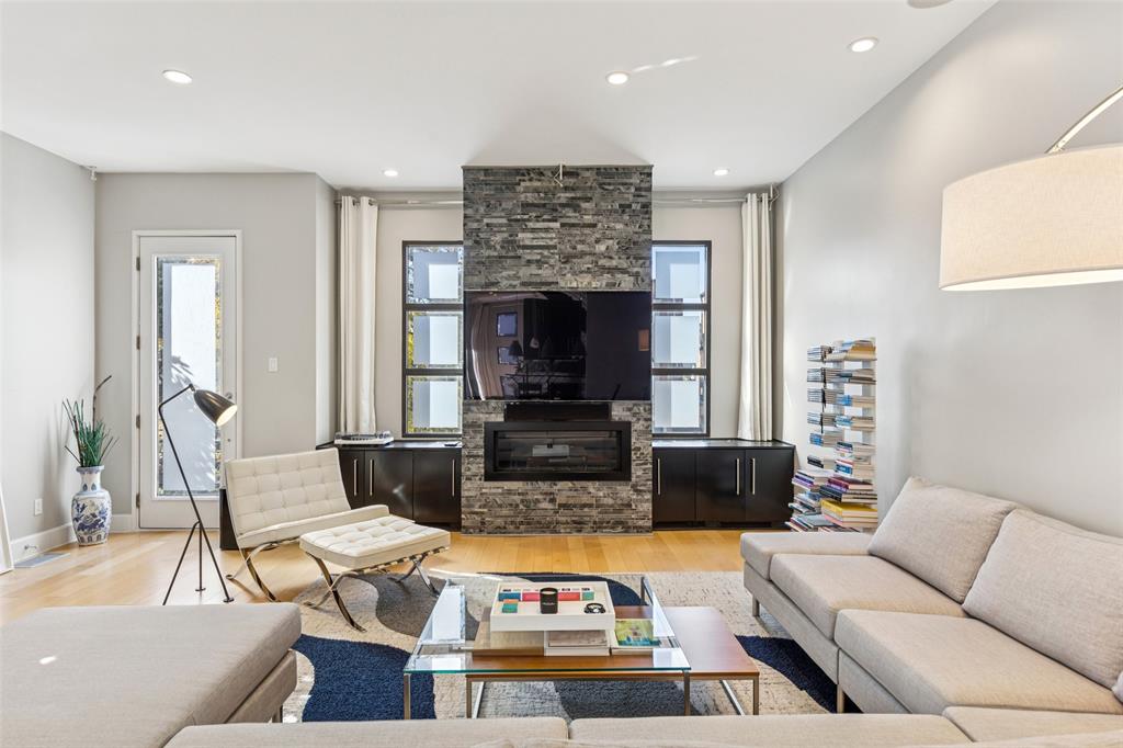 4420 Holland Avenue, Unit A Dallas, TX 75219 - Photo 4 of 32 a living room with furniture fireplace and a flat screen tv