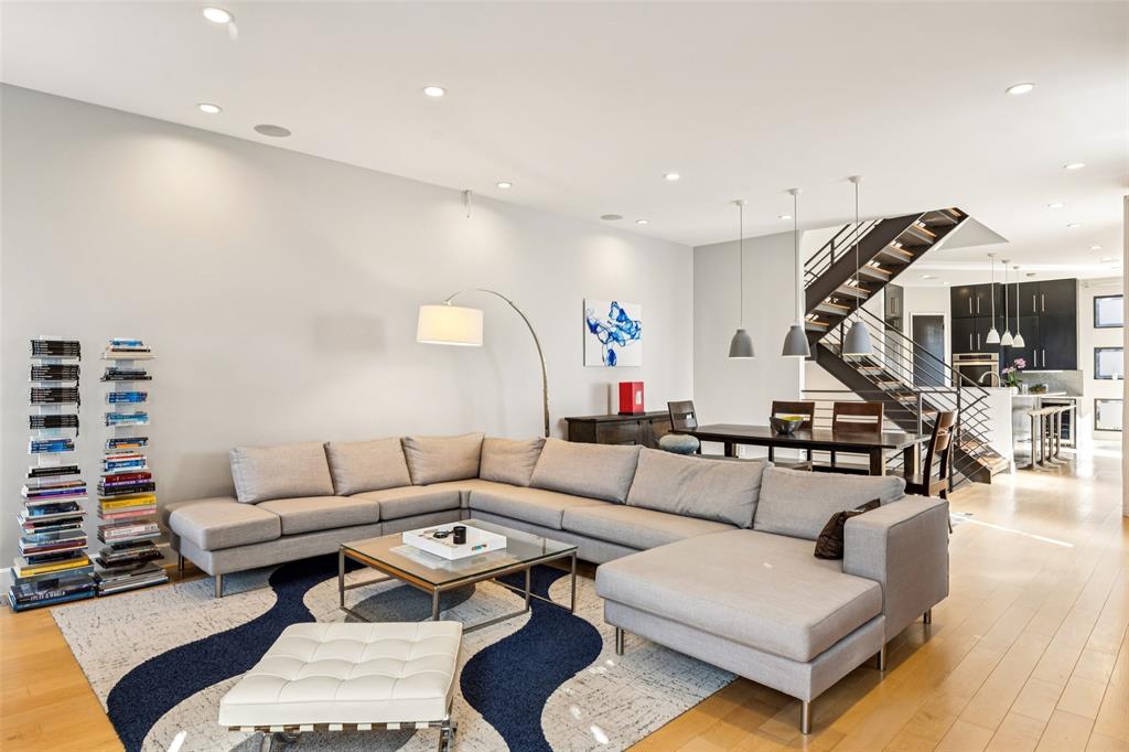 4420 Holland Avenue, Unit A Dallas, TX 75219 - Photo 6 of 32 a living room with furniture a rug and a chandelier