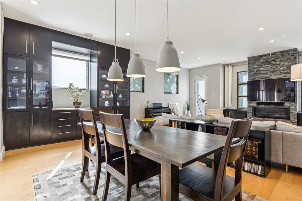 4420 Holland Avenue, Unit A Dallas, TX 75219 - Photo 8 of 32 a dining room with furniture a chandelier and wooden floor