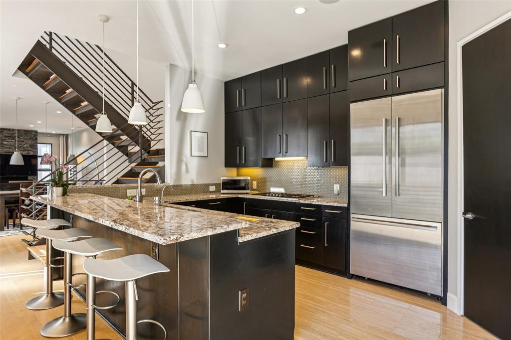 4420 Holland Avenue, Unit A Dallas, TX 75219 - Photo 9 of 32 a kitchen with stainless steel appliances granite countertop a sink and a refrigerator